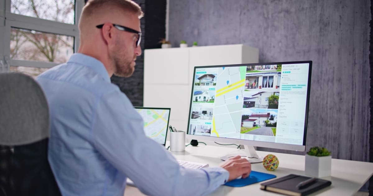 A man looks at a property listing on a computer screen, property managers in Baltimore concept