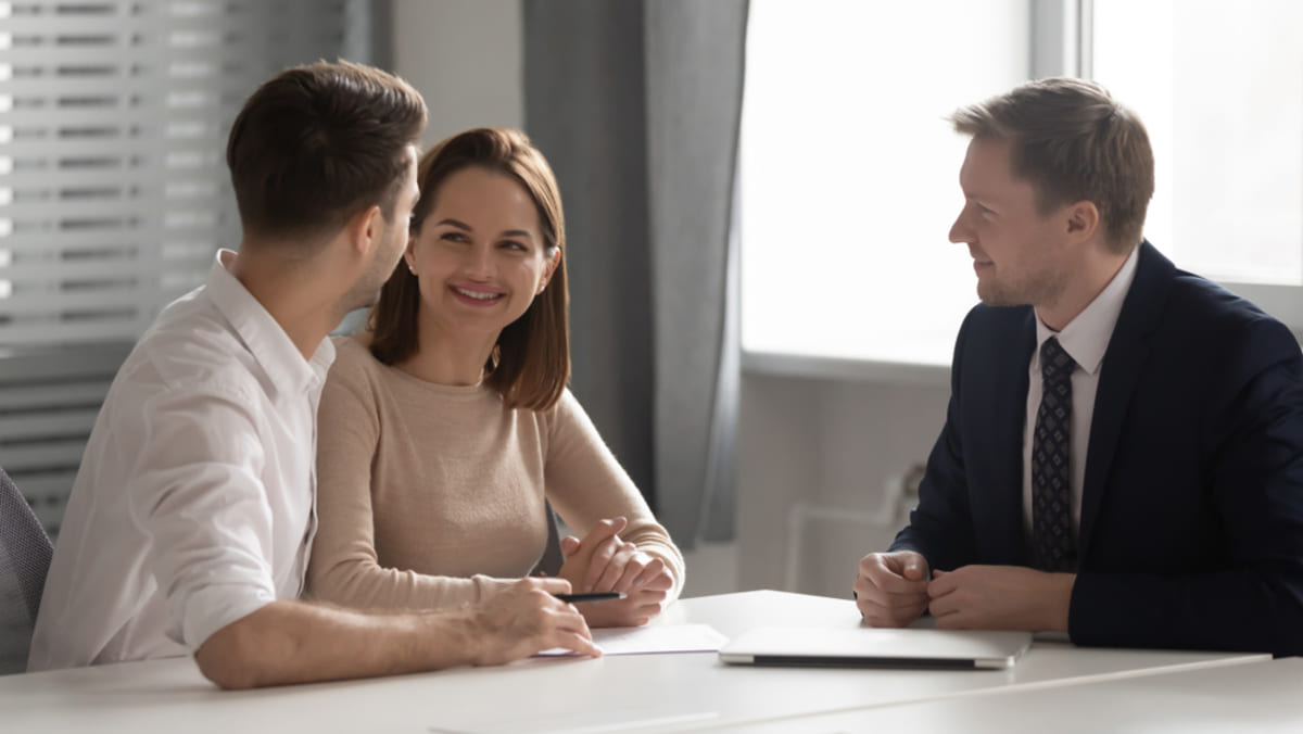 A property manager meets with a couple, working with Baltimore property managers concept