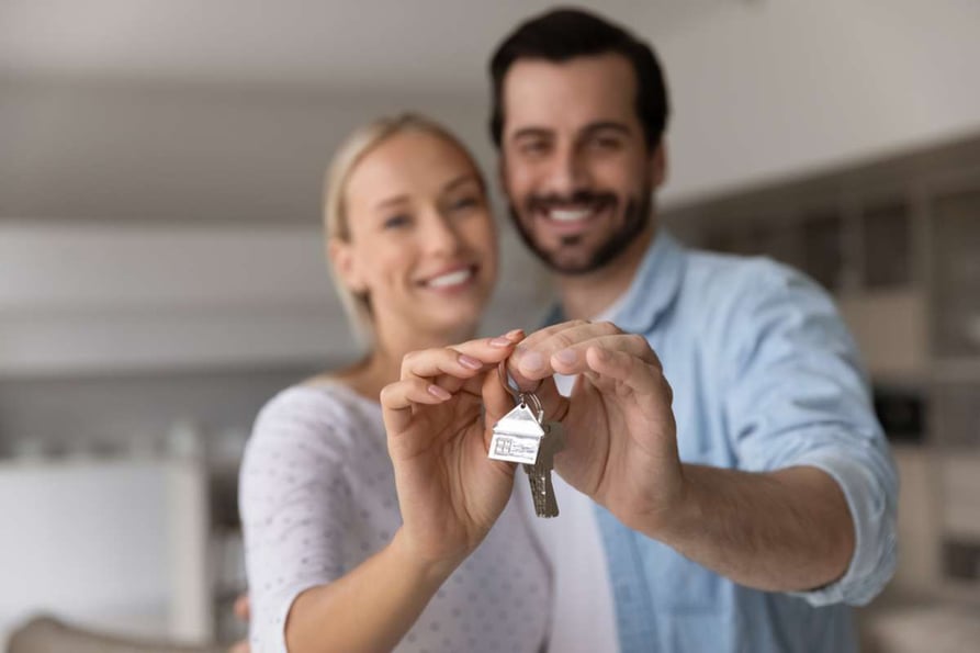 Close up focus of happy young Caucasian couple show keys to first share own apartment or house