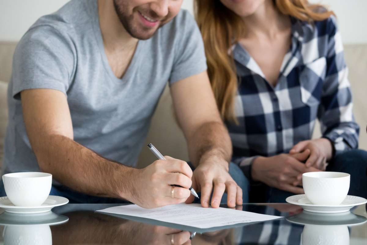 Close up view of couple signing documents