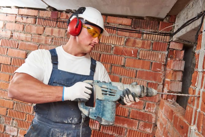 Construction worker with drill perforator