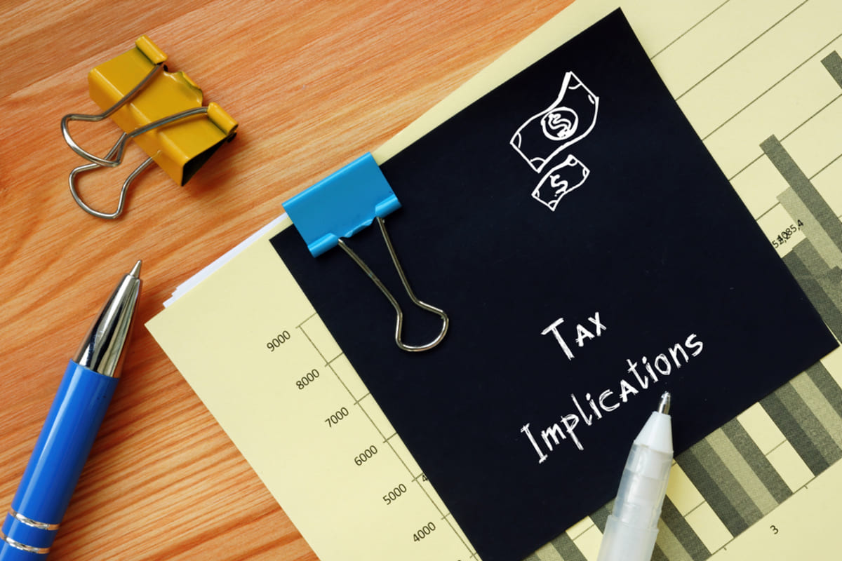 Financial concept about Tax Implications with inscription on the piece of paper