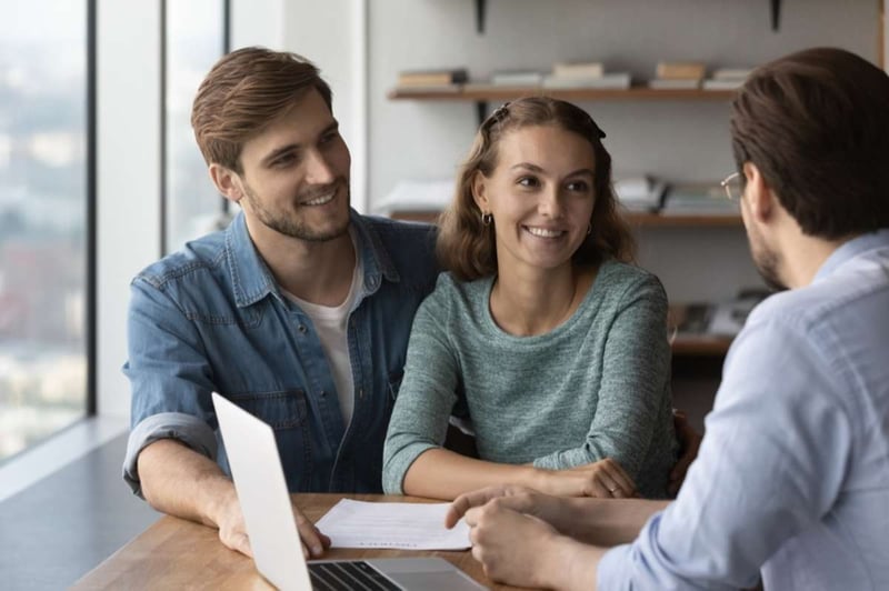 Happy couple signs a lease for renewal, Baltimore property management services concept