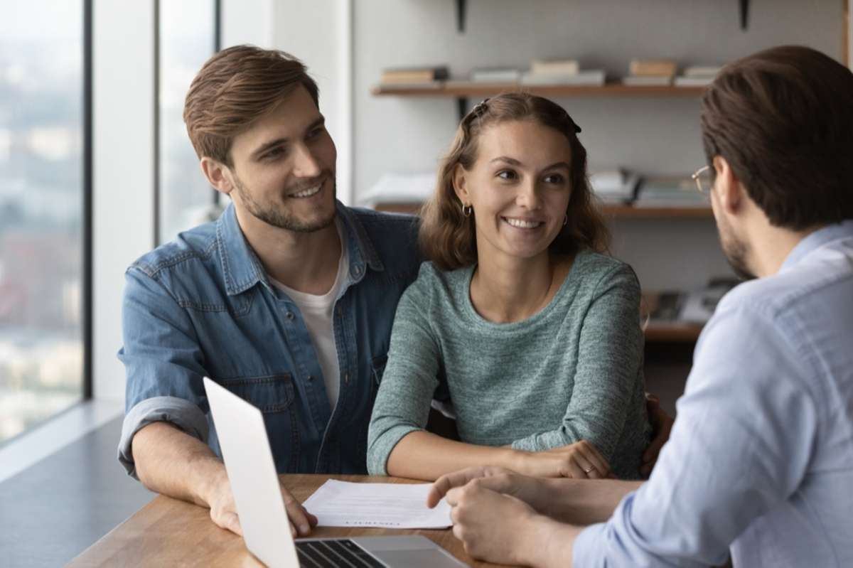 Happy couple signs a lease for renewal, Baltimore property management services concept