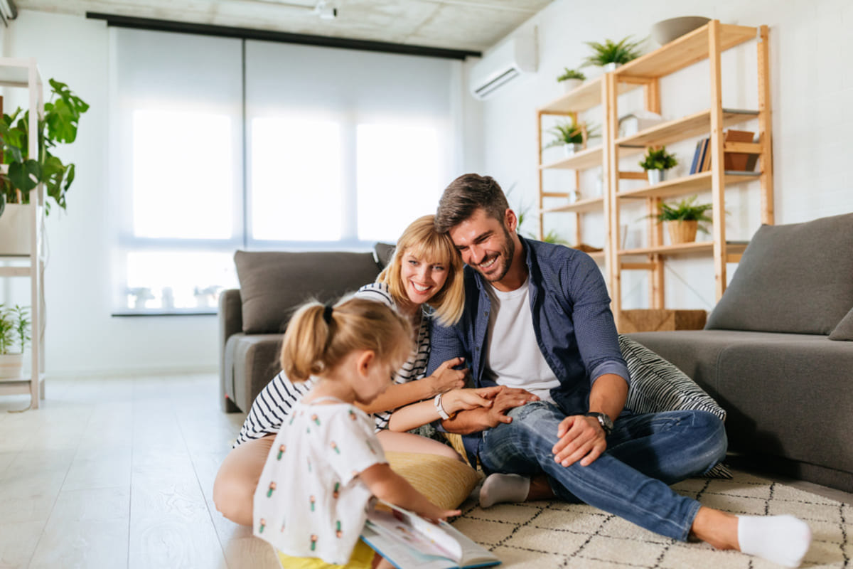 Happy family on the floor of a home, expert Baltimore property management concept