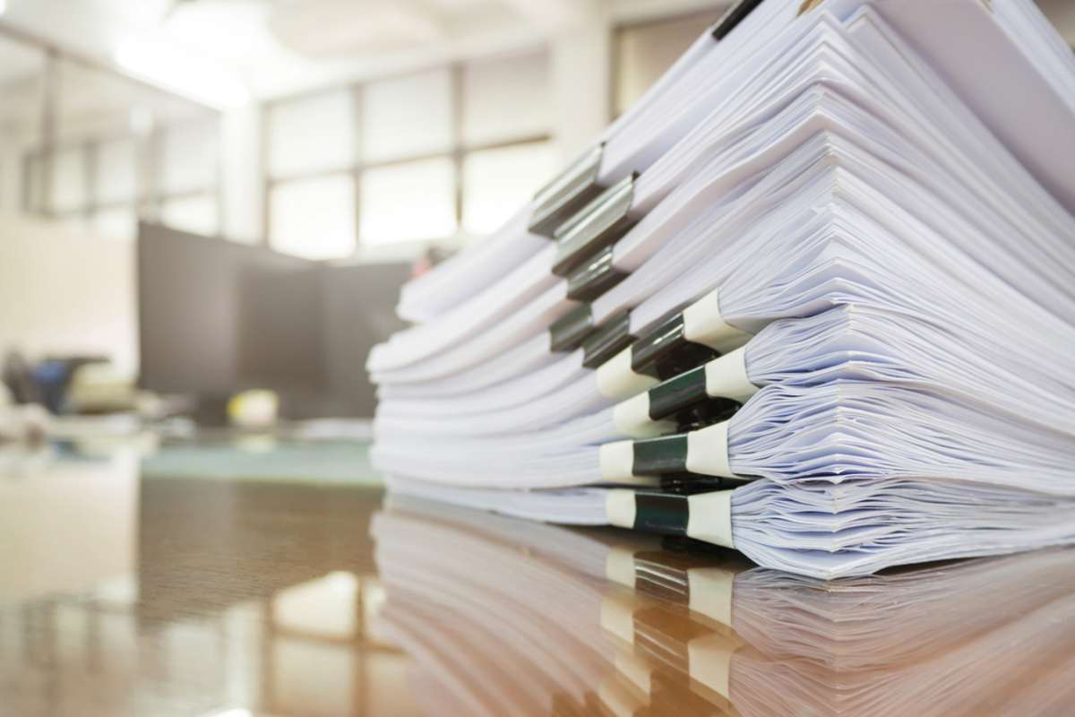 Pile of unfinished documents on office desk, Stack of business paper