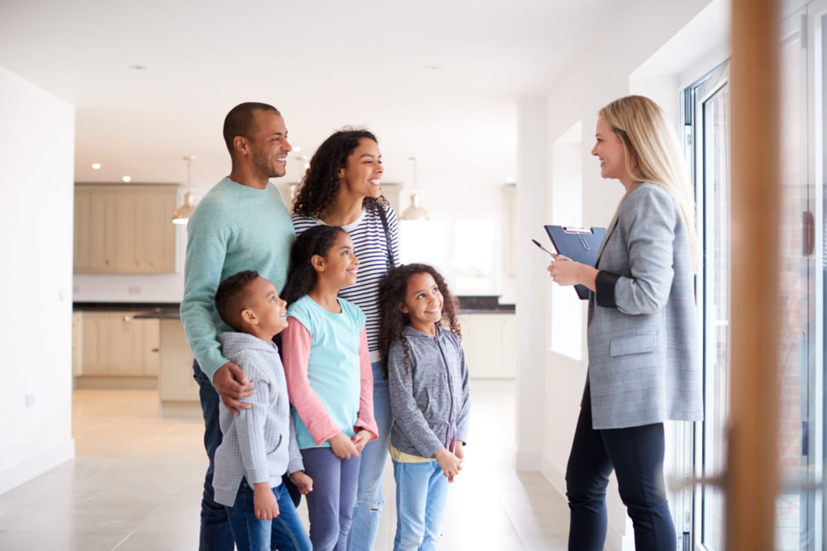 Property managers in Baltimore show a property to a family