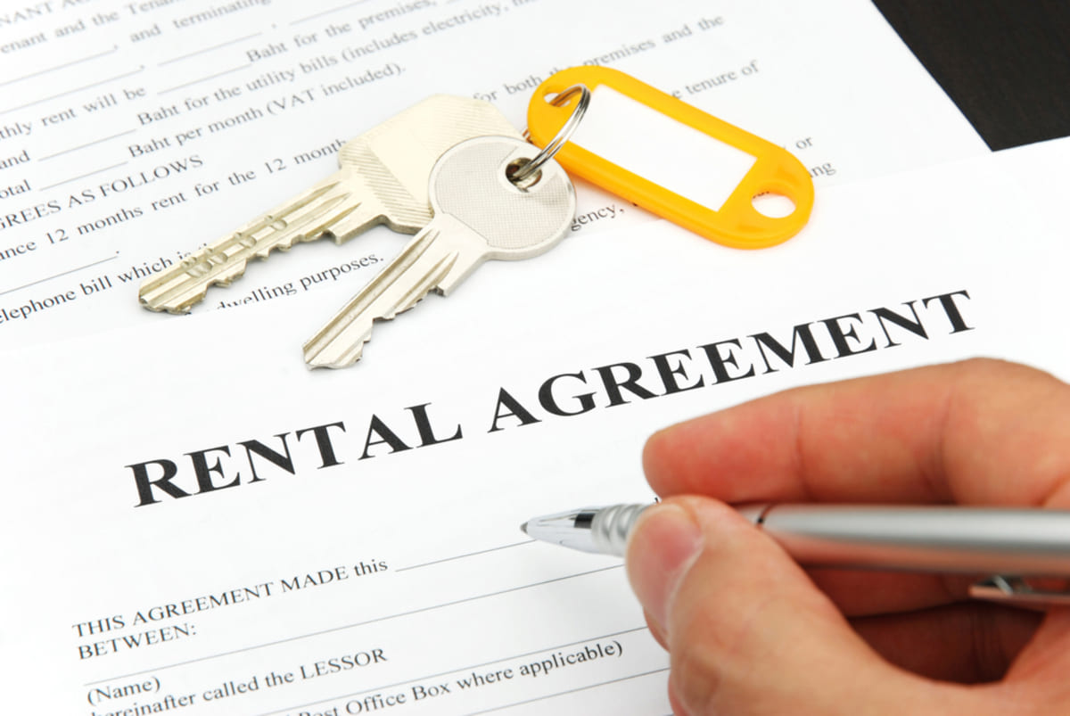 Rental agreement with signing hand and keys