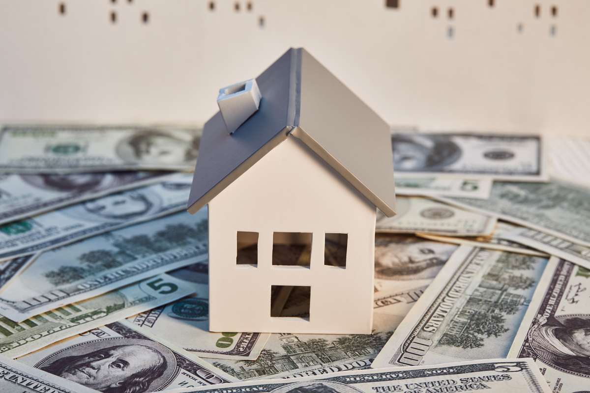White house model on dollar banknotes, real estate concept