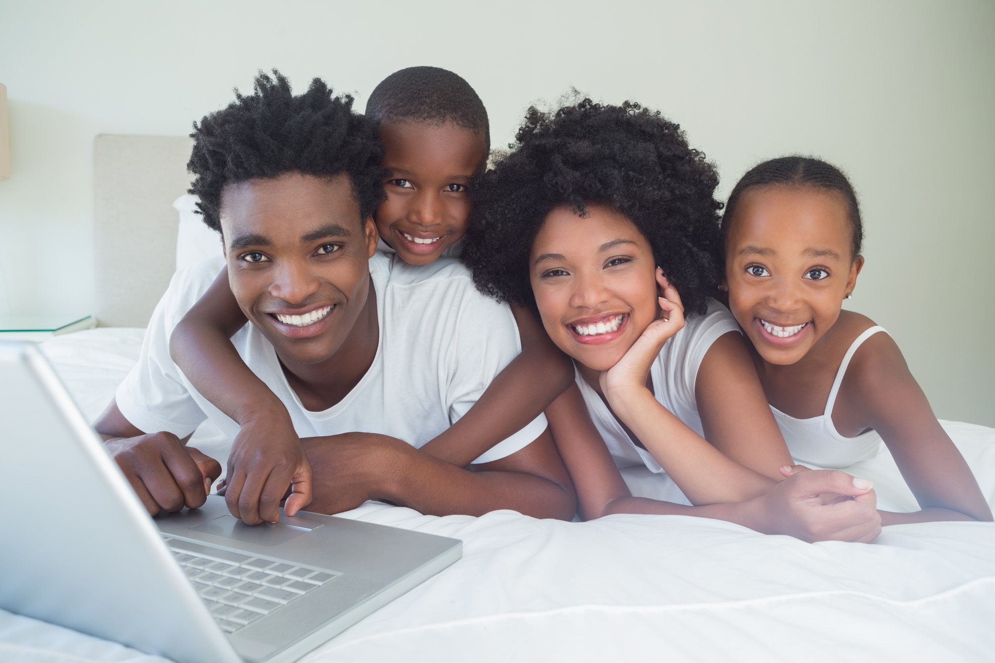 Happy family using the laptop together