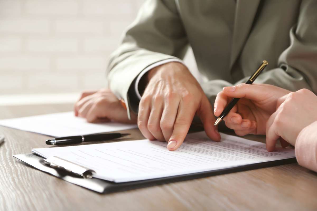 Human hands working with documents at the desk closeup