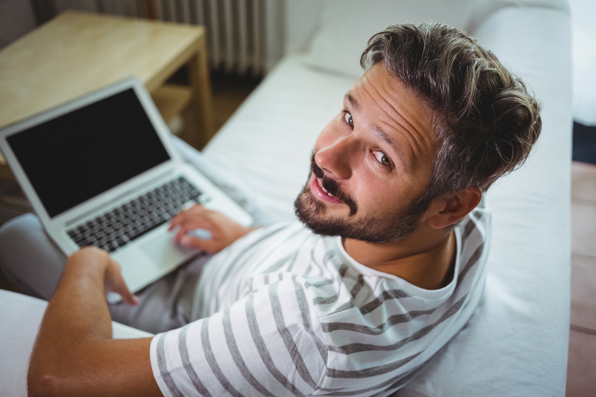 Man using his laptop in living room