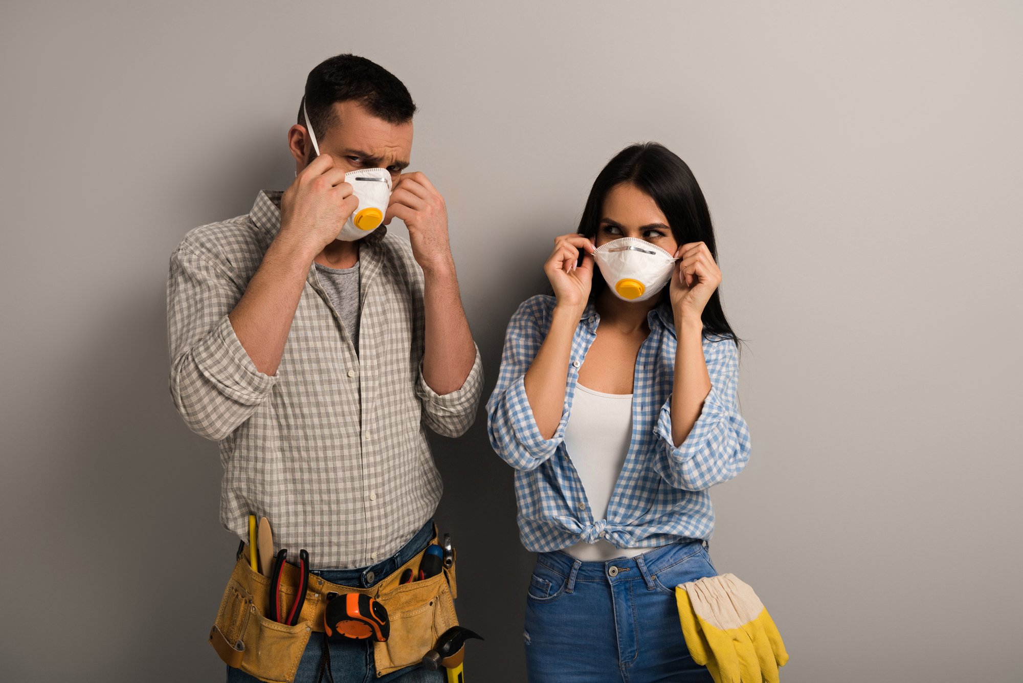 Manual workers wearing safety masks on grey