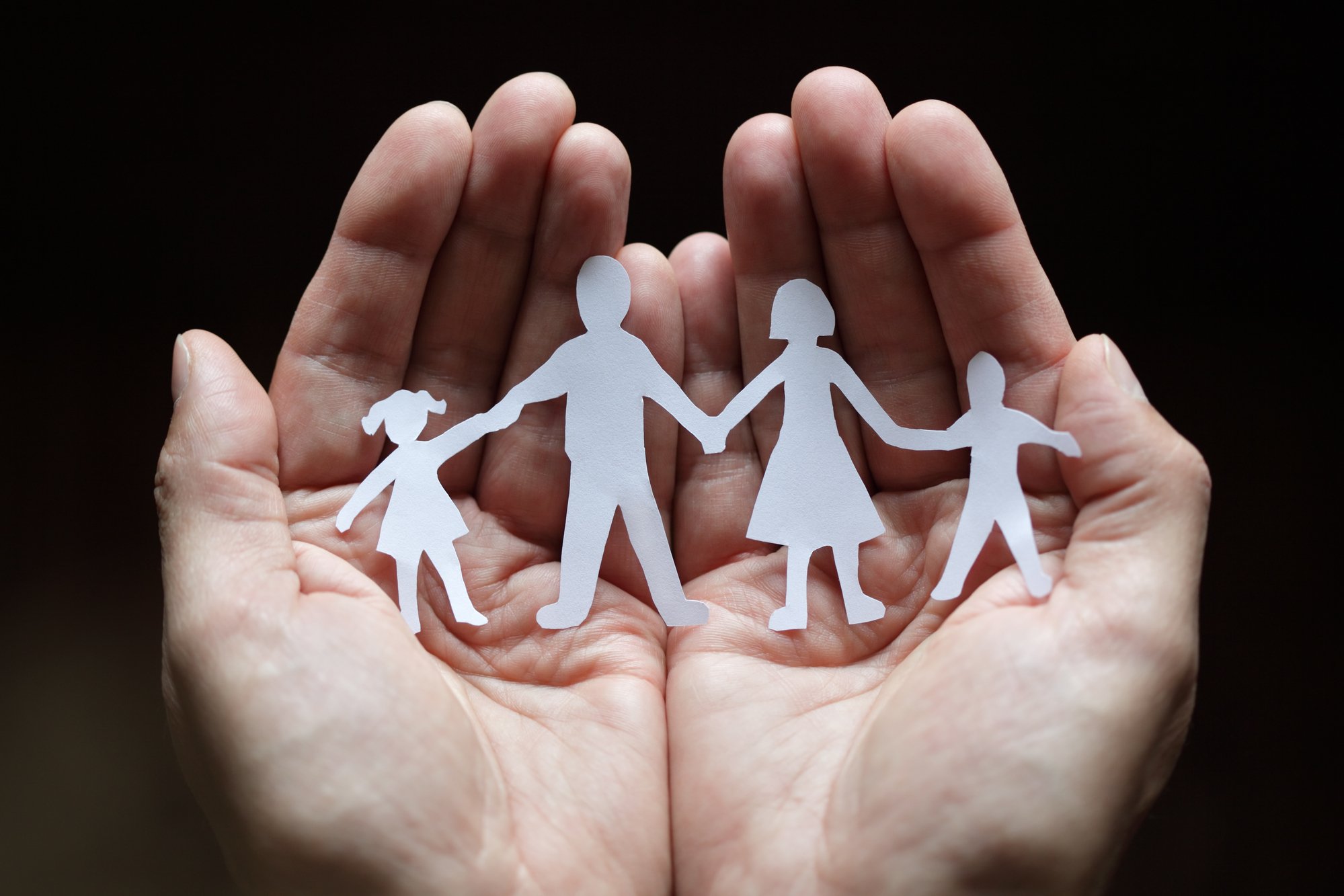 Paper chain family protected in cupped hands