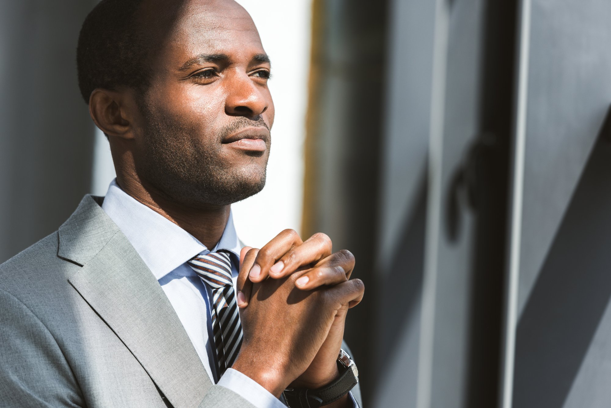 Portrait of handsome young african american businessman looking away