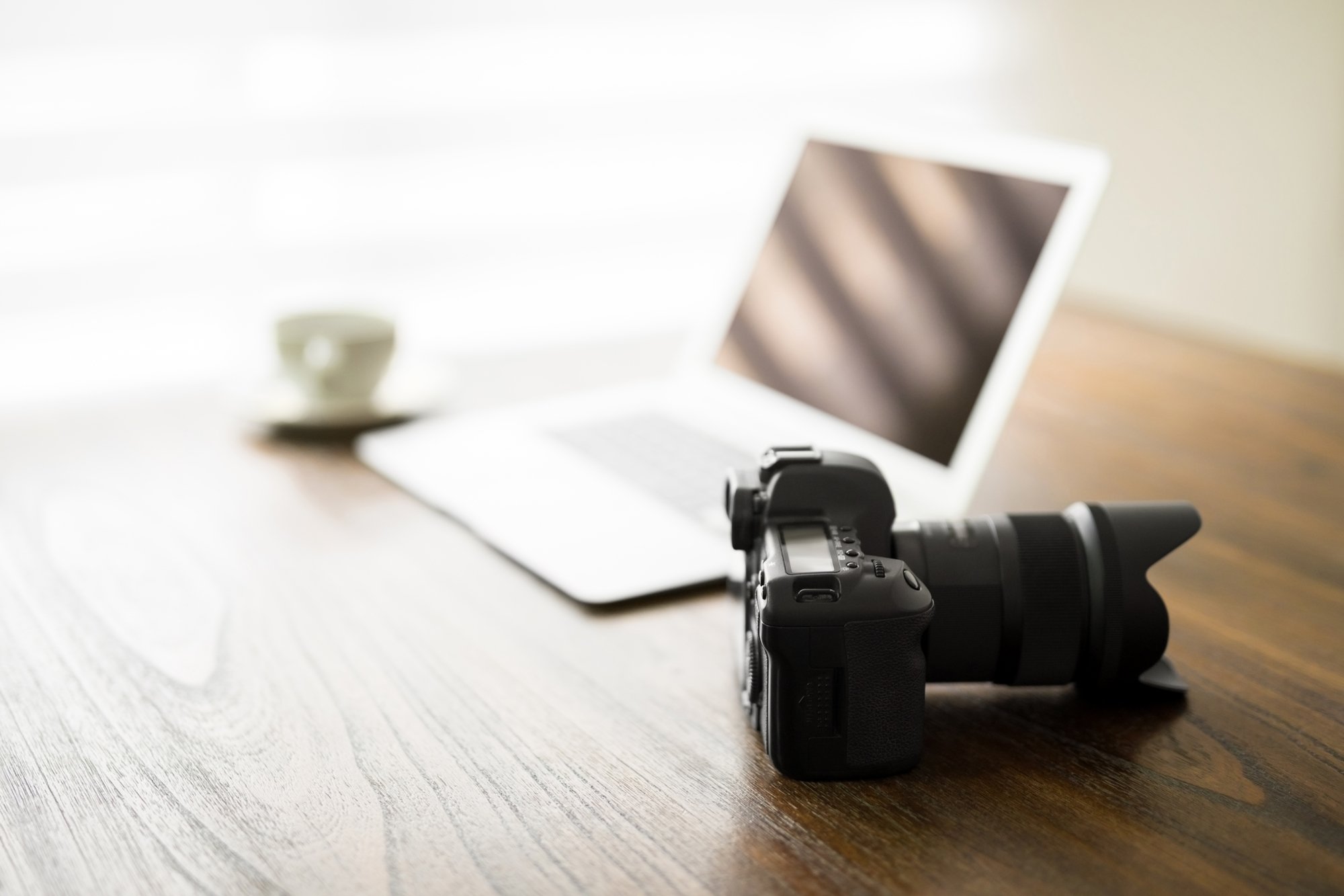 Professional camera on desk, taking quality listing photos for Maryland rental homes concept. 