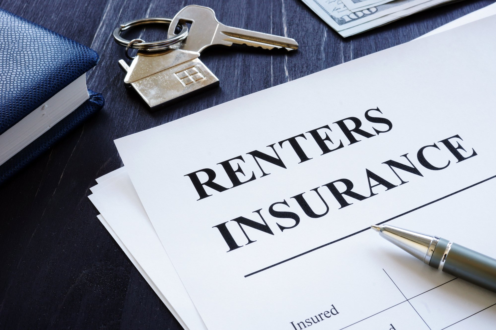 Renters Insurance policy agreement and key from apartments
