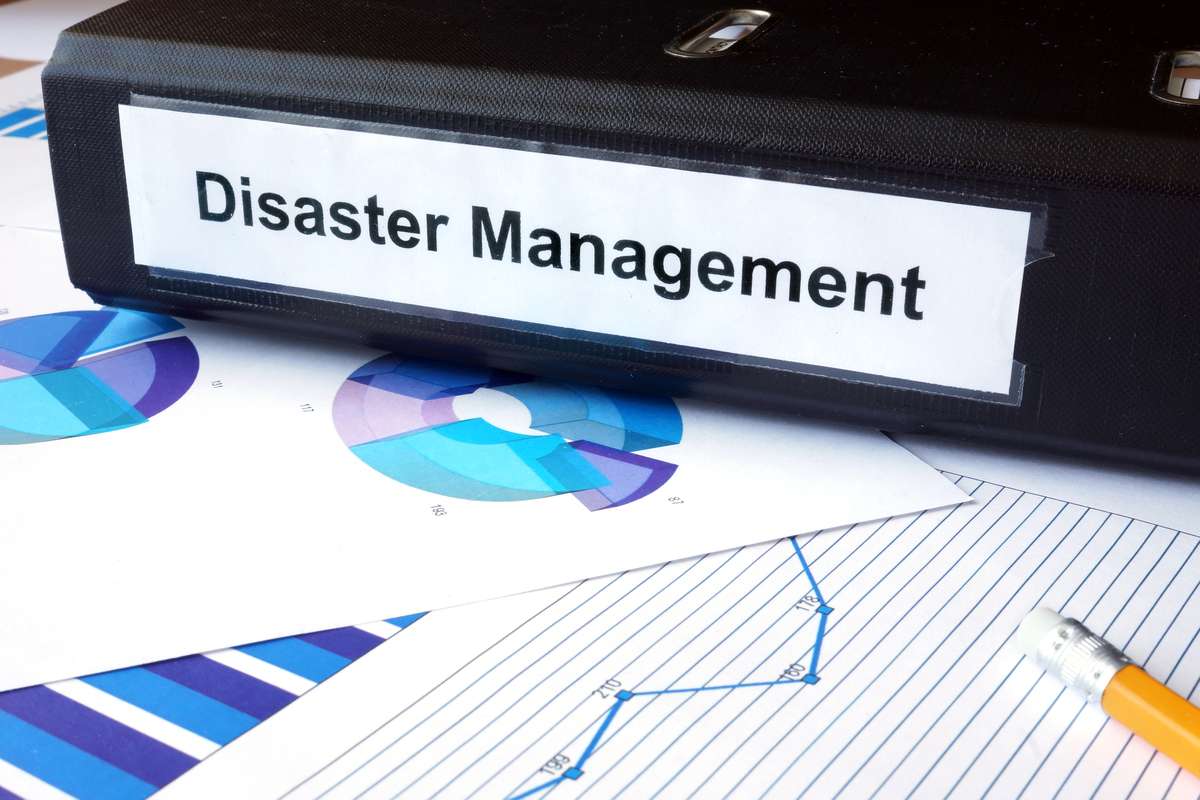 Graphs and file folder with label Disaster Management