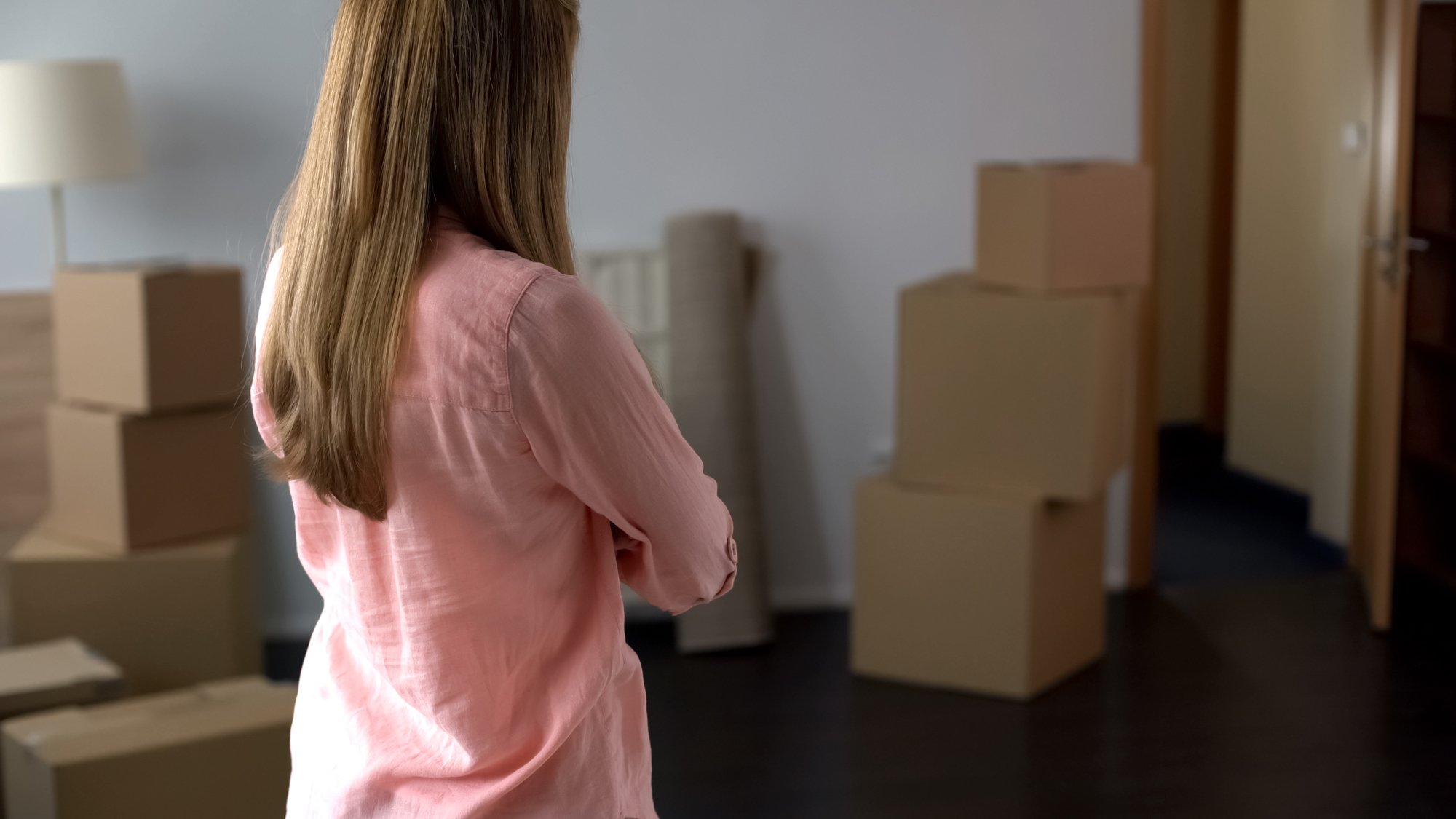 Woman looking at exit from apartment, non-payment of loan and loss of housing