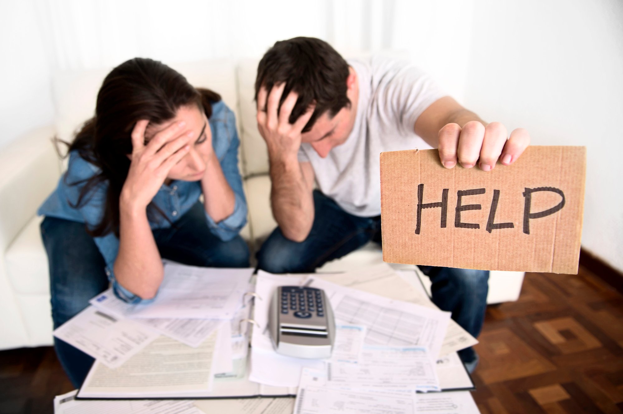 Young couple worried at home in bad financial situation stress asking for help