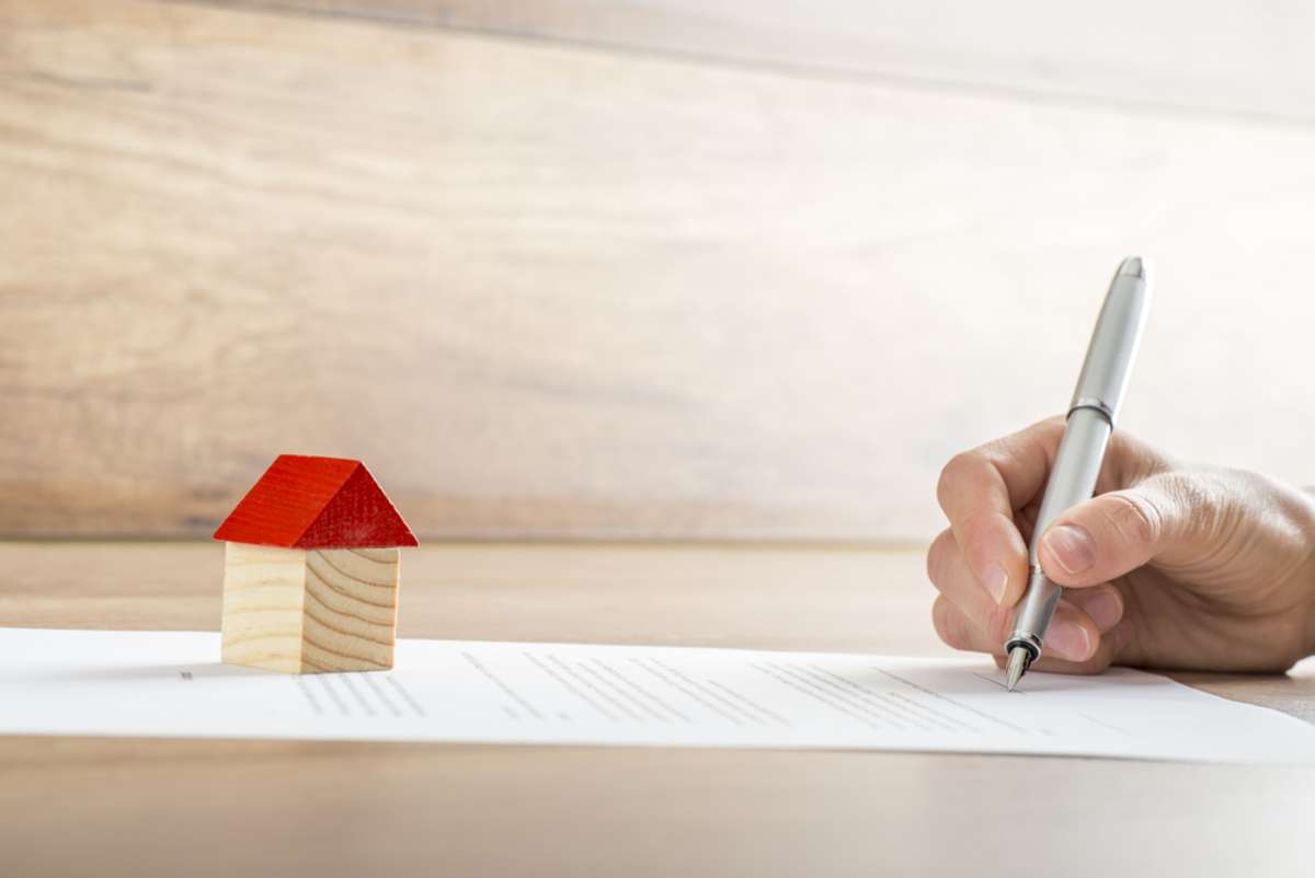 new homeowner signing a contract of house sale