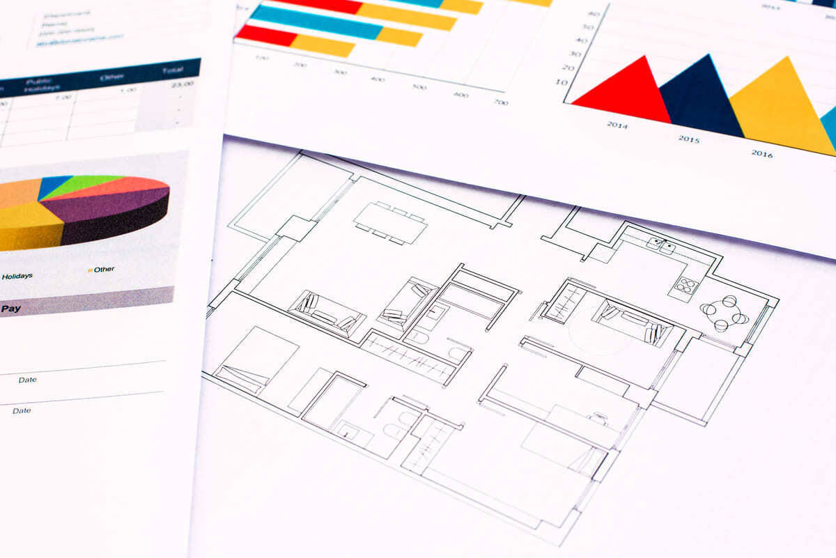 A floorplan and rental analysis report on a table