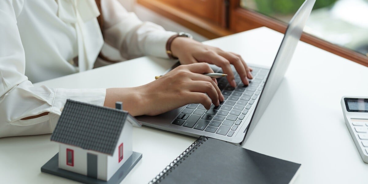 A real estate professional using a laptop