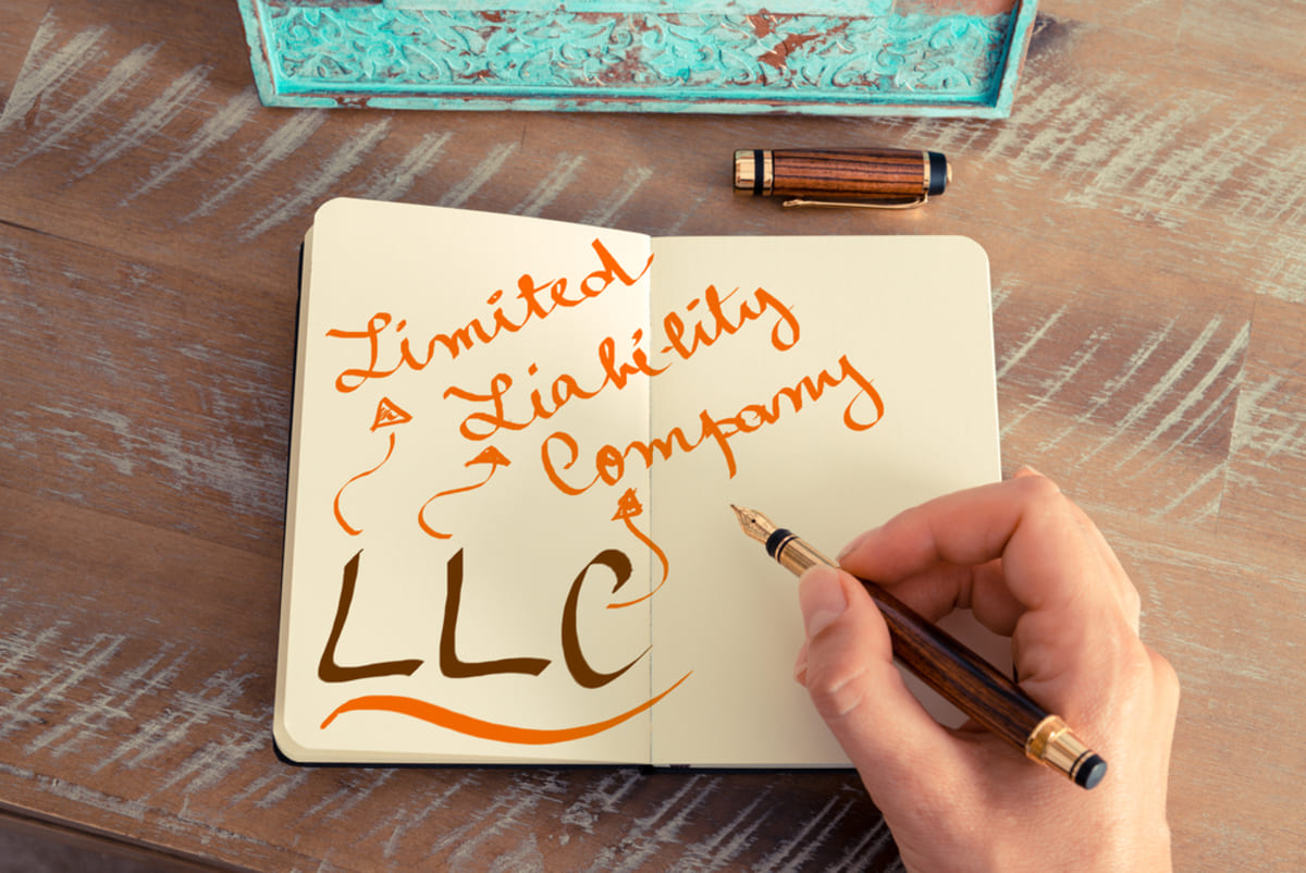 Handwritten text LLC LIMITED LIABILITY COMPANY, business success