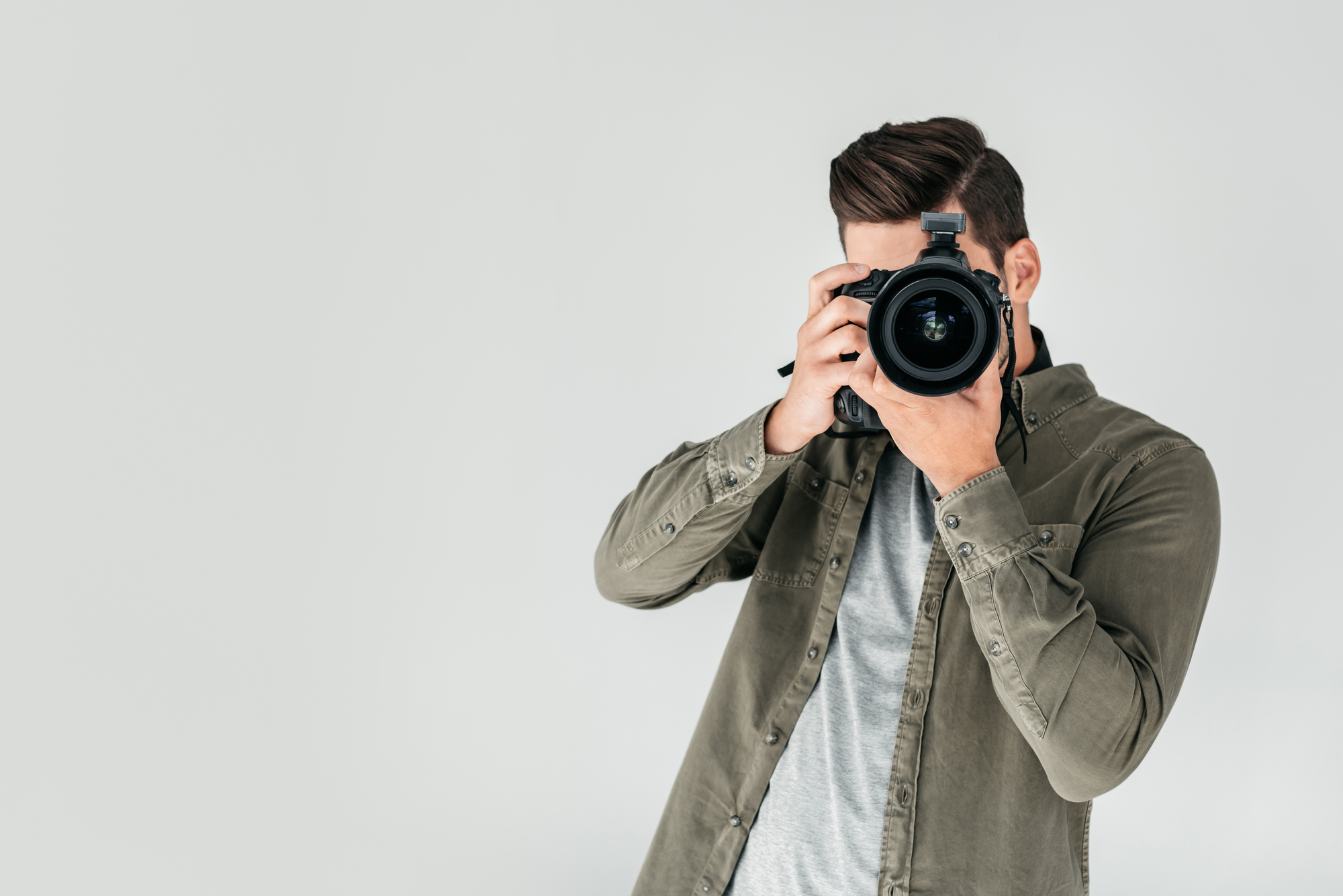 Photographer with digital photo camera for taking photos for a rental property listing. 